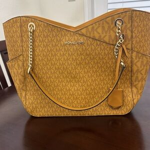 Brand new never used mustard colored Michael Kors purse